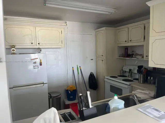 a kitchen with stainless steel appliances a refrigerator and a sink