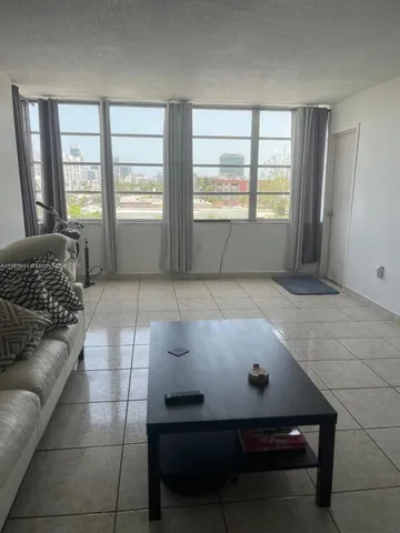 a living room with a couch and next to a window