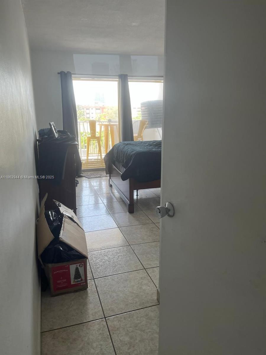 8000 Harding Avenue, Unit 5B Miami Beach, FL 33141 - Photo 6 of 6 a living room with furniture and a window