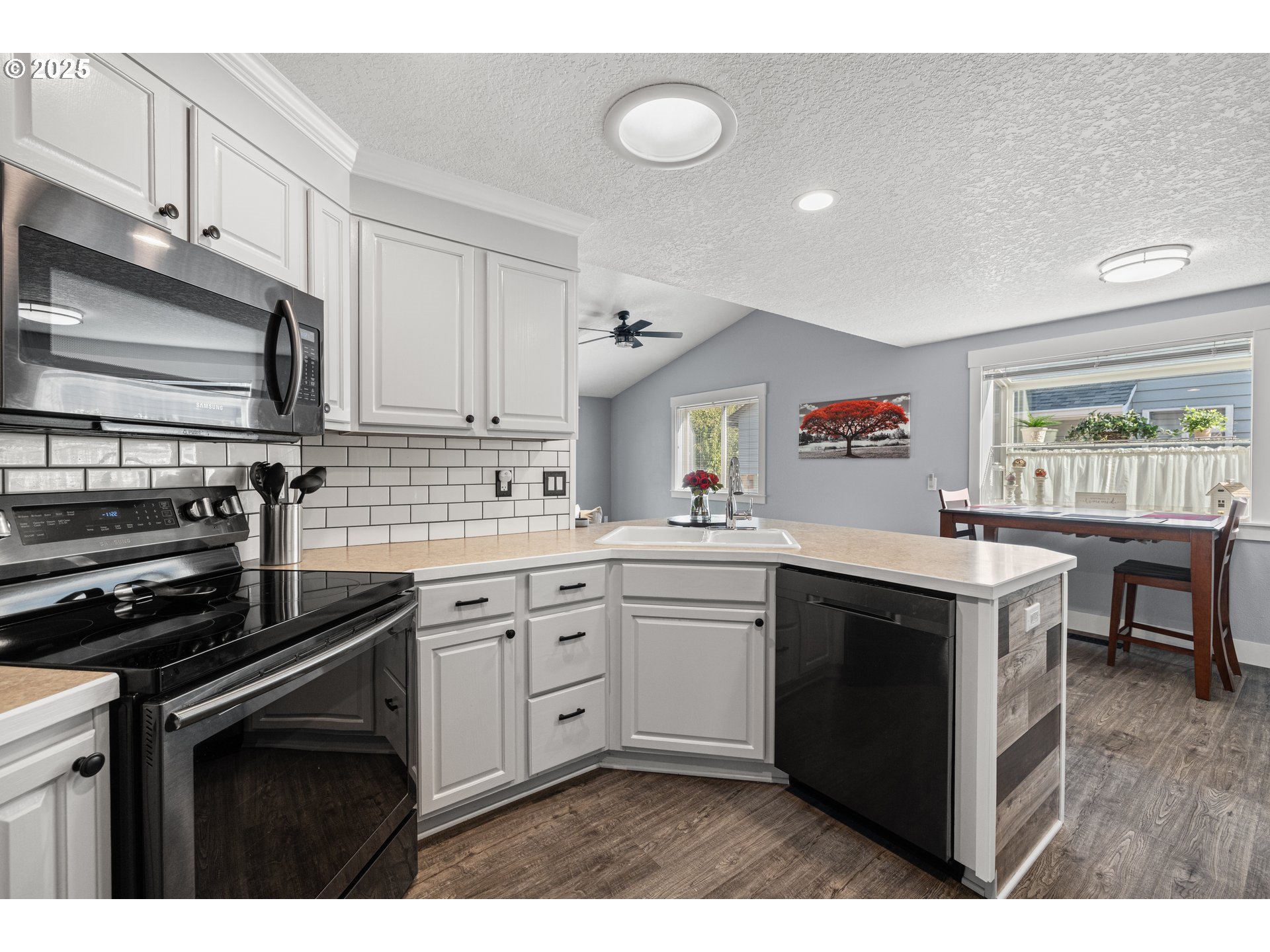 7243 Southwest Applegate Drive Beaverton, OR 97007 - Photo 11 of 39 a kitchen with a stove sink and cabinets