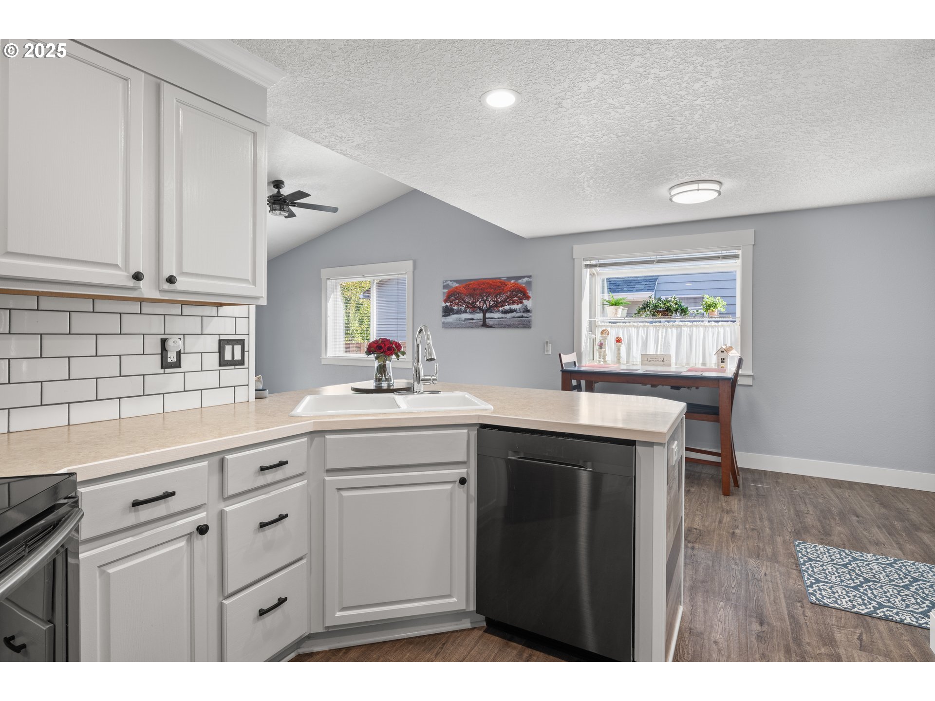 7243 Southwest Applegate Drive Beaverton, OR 97007 - Photo 12 of 39 a kitchen with cabinets wooden floor and a window