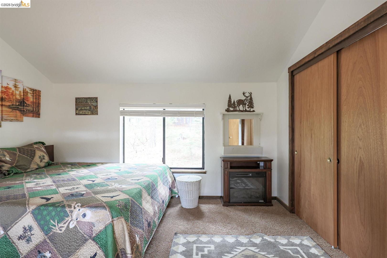 26600 Inyo Drive Cold Springs, CA 95335 - Photo 32 of 38 a bedroom with a bed and a window
