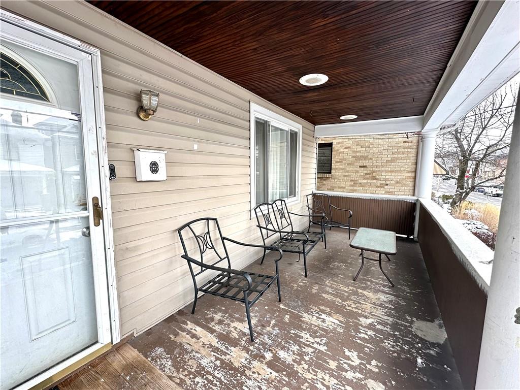 544 Woodward Avenue McKees Rocks, PA 15136 - Photo 2 of 13 a view of a patio with table and chairs and couches with wooden floor and fence