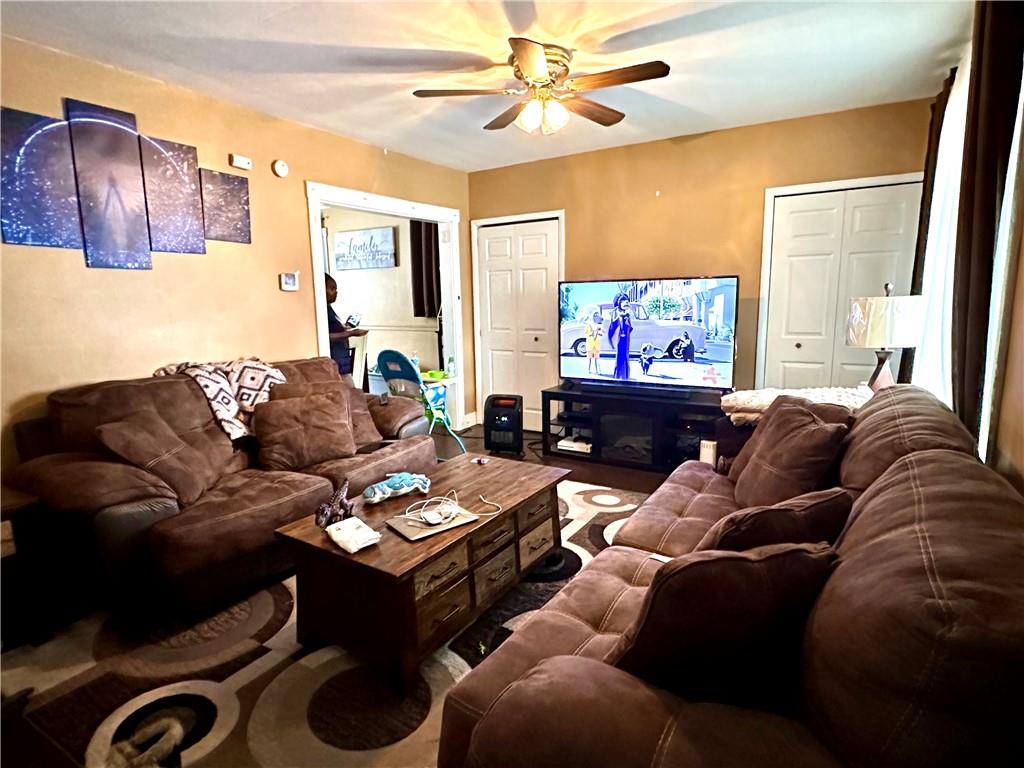 544 Woodward Avenue McKees Rocks, PA 15136 - Photo 3 of 13 a living room with furniture a large window and a flat screen tv