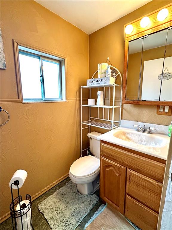 544 Woodward Avenue McKees Rocks, PA 15136 - Photo 5 of 13 a bathroom with a toilet a sink and mirror