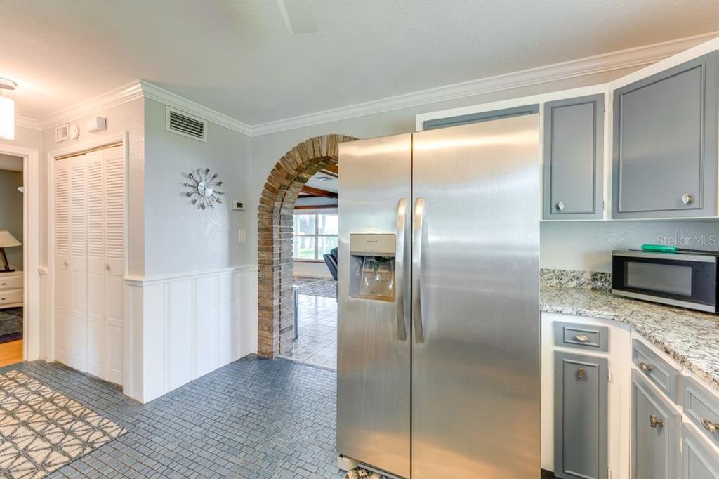 900 North Harbor Terrace Road Tavares, FL 32778 - Photo 12 of 58 a kitchen with granite countertop a refrigerator and a sink
