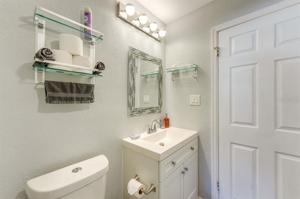 900 North Harbor Terrace Road Tavares, FL 32778 - Photo 15 of 58 a bathroom with a sink mirror vanity and toilet