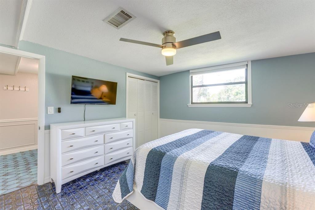 900 North Harbor Terrace Road Tavares, FL 32778 - Photo 17 of 58 a bedroom with a bed and a flat screen tv