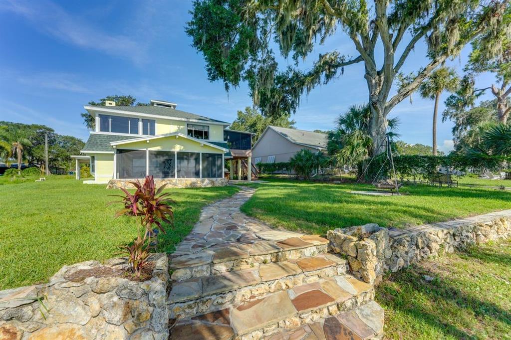 900 North Harbor Terrace Road Tavares, FL 32778 - Photo 2 of 58 a front view of a house with a yard