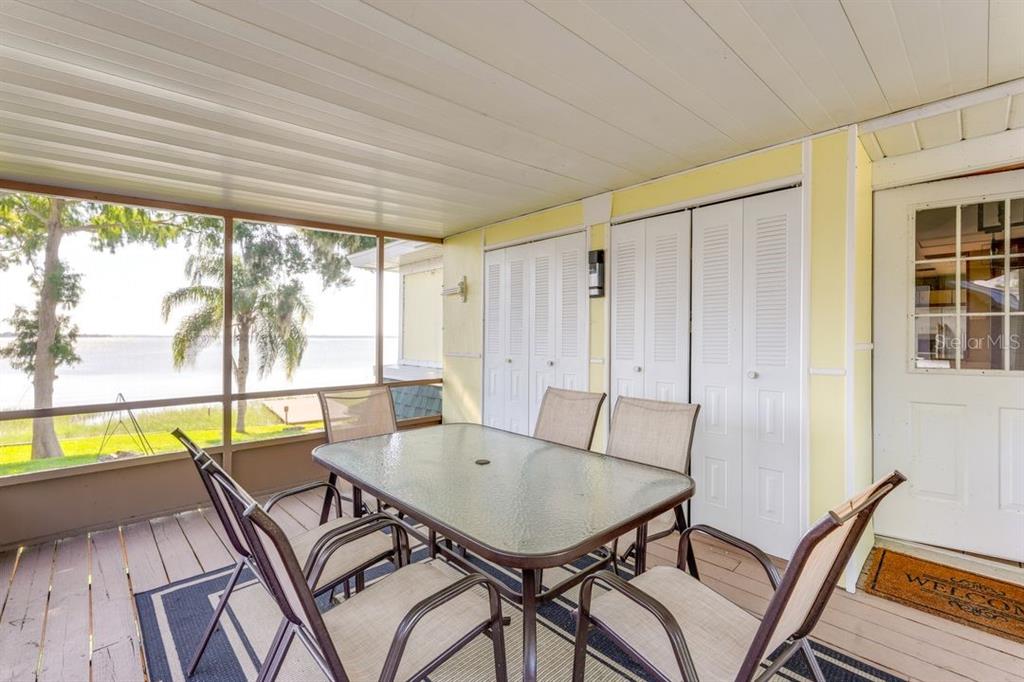 900 North Harbor Terrace Road Tavares, FL 32778 - Photo 23 of 58 a view of a dining room with furniture a rug and wooden floor