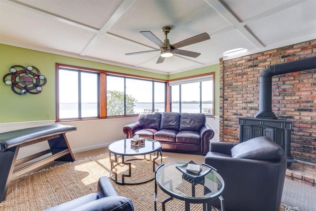 900 North Harbor Terrace Road Tavares, FL 32778 - Photo 26 of 58 a living room with furniture a fireplace and a large window