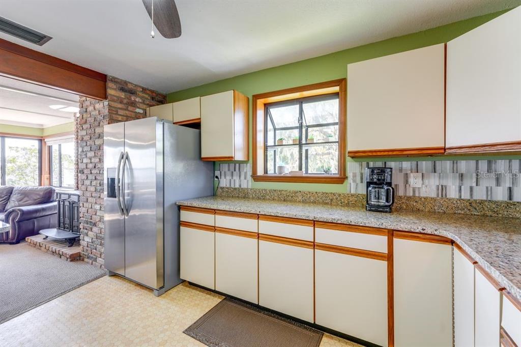 900 North Harbor Terrace Road Tavares, FL 32778 - Photo 34 of 58 a kitchen with stainless steel appliances granite countertop a sink and a refrigerator