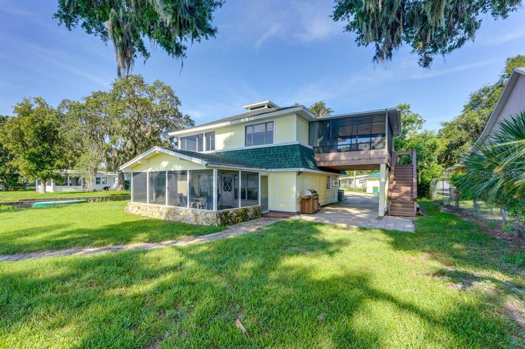 900 North Harbor Terrace Road Tavares, FL 32778 - Photo 35 of 58 a view of a house with a yard porch and sitting area