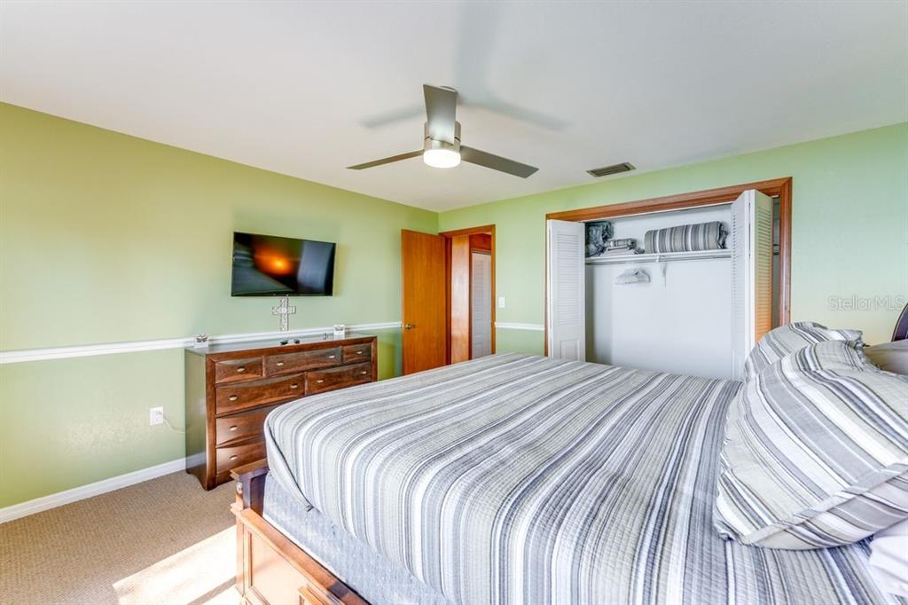 900 North Harbor Terrace Road Tavares, FL 32778 - Photo 39 of 58 a bedroom with a bed and a flat screen tv