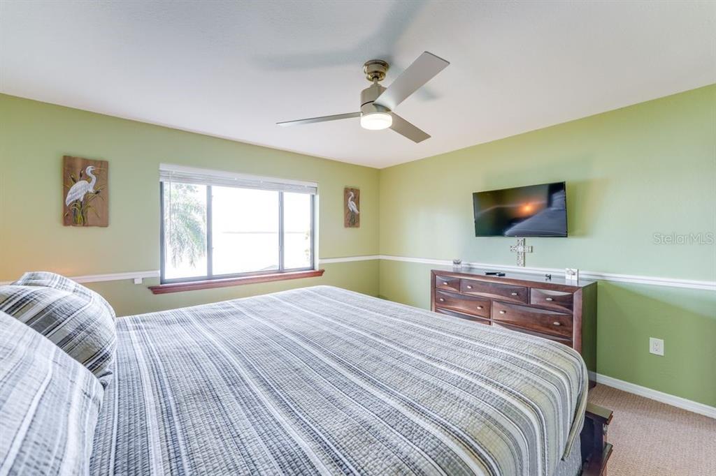 900 North Harbor Terrace Road Tavares, FL 32778 - Photo 40 of 58 a bedroom with a bed and a flat screen tv