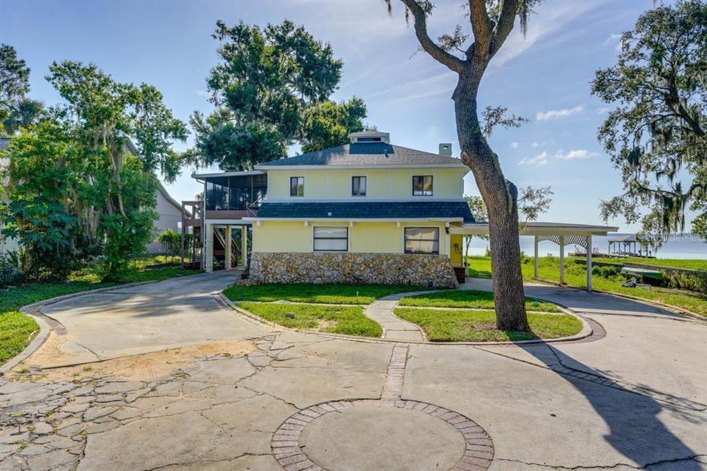 900 North Harbor Terrace Road Tavares, FL 32778 - Photo 47 of 58 a front view of a house with a yard and a garage
