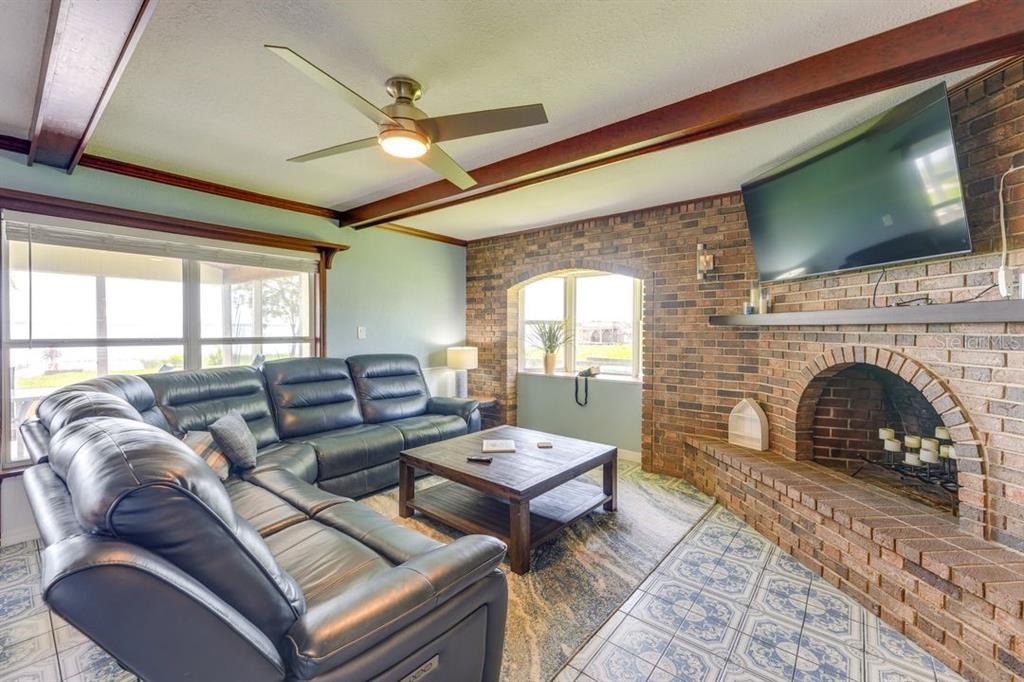 900 North Harbor Terrace Road Tavares, FL 32778 - Photo 6 of 58 a living room with furniture a flat screen tv and a fireplace
