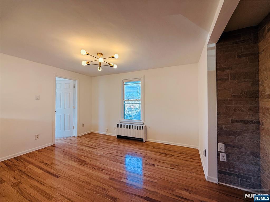 86 West Main Street, Unit 2 Bergenfield, NJ 07621 - Photo 3 of 12 wooden floor in an empty room with a window