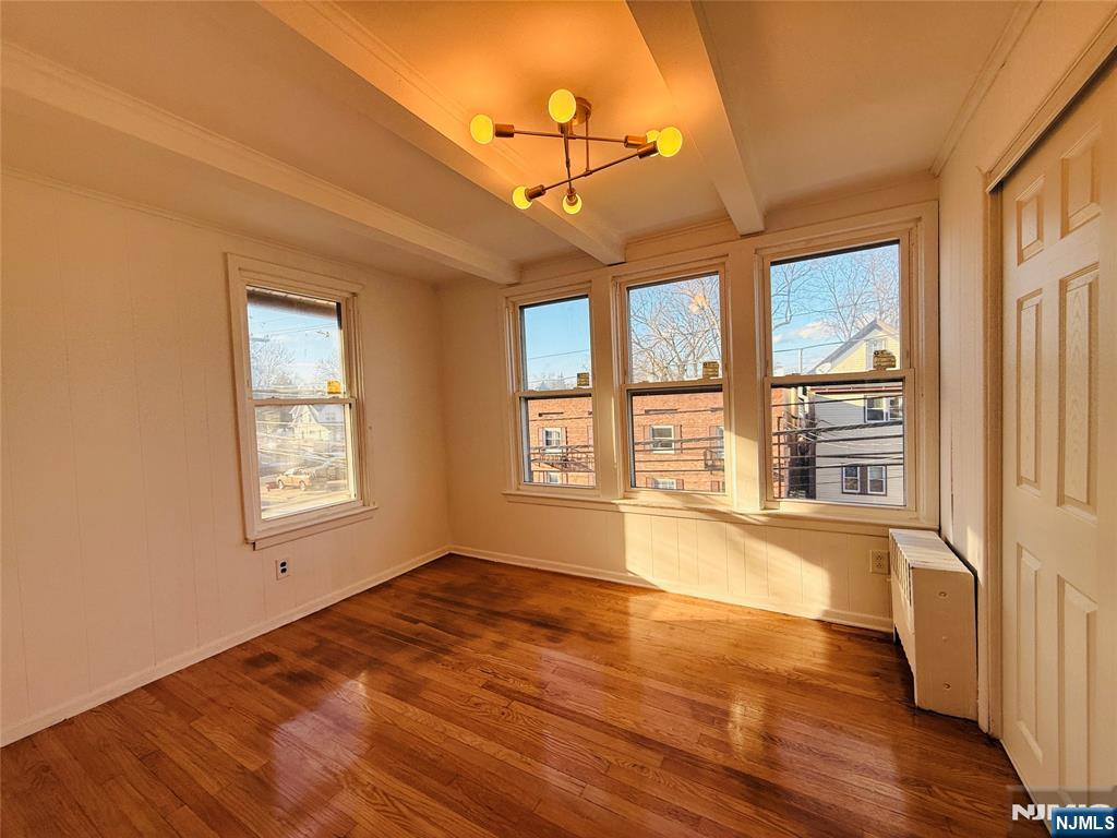 86 West Main Street, Unit 2 Bergenfield, NJ 07621 - Photo 4 of 12 a view of an empty room with a window and wooden floor