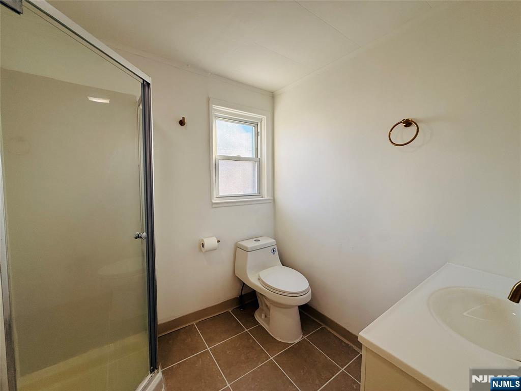 86 West Main Street, Unit 2 Bergenfield, NJ 07621 - Photo 10 of 12 a bathroom with a toilet a sink and a shower