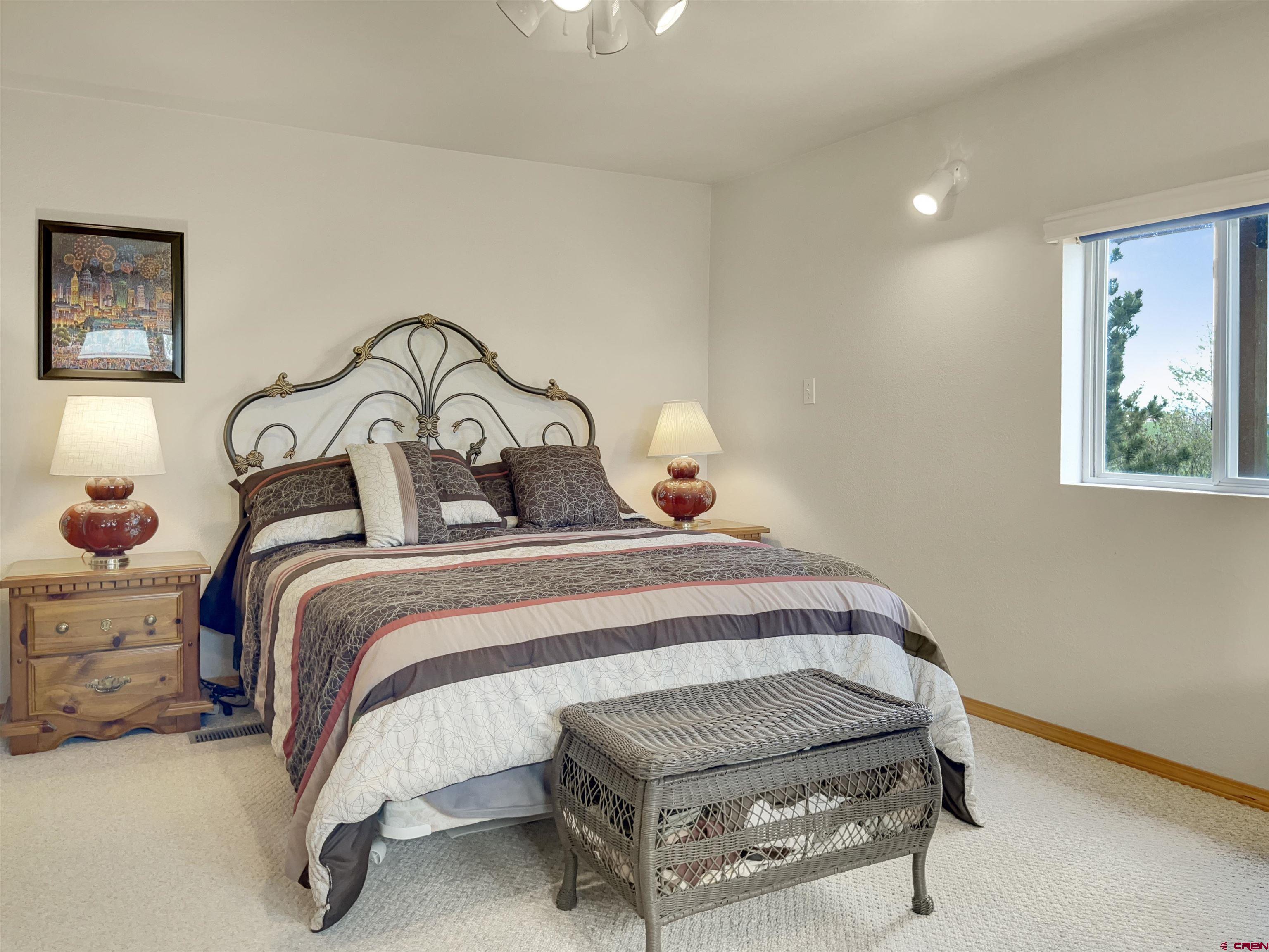 15200 Rd CC Pleasant View, CO 81331 - Photo 28 of 35 a bedroom with a bed and lamp with window