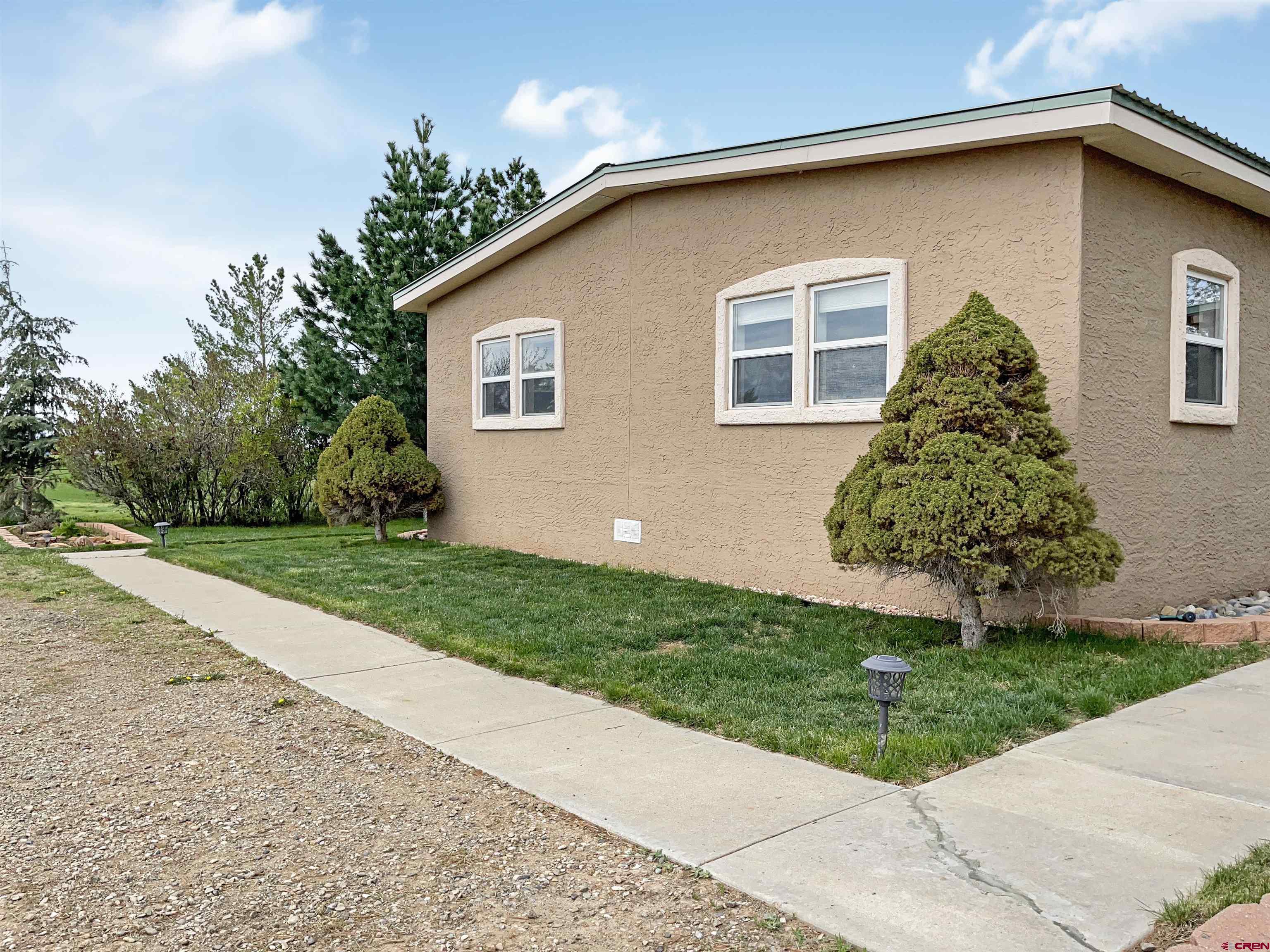 15200 Rd CC Pleasant View, CO 81331 - Photo 3 of 35 a front view of a house with a yard