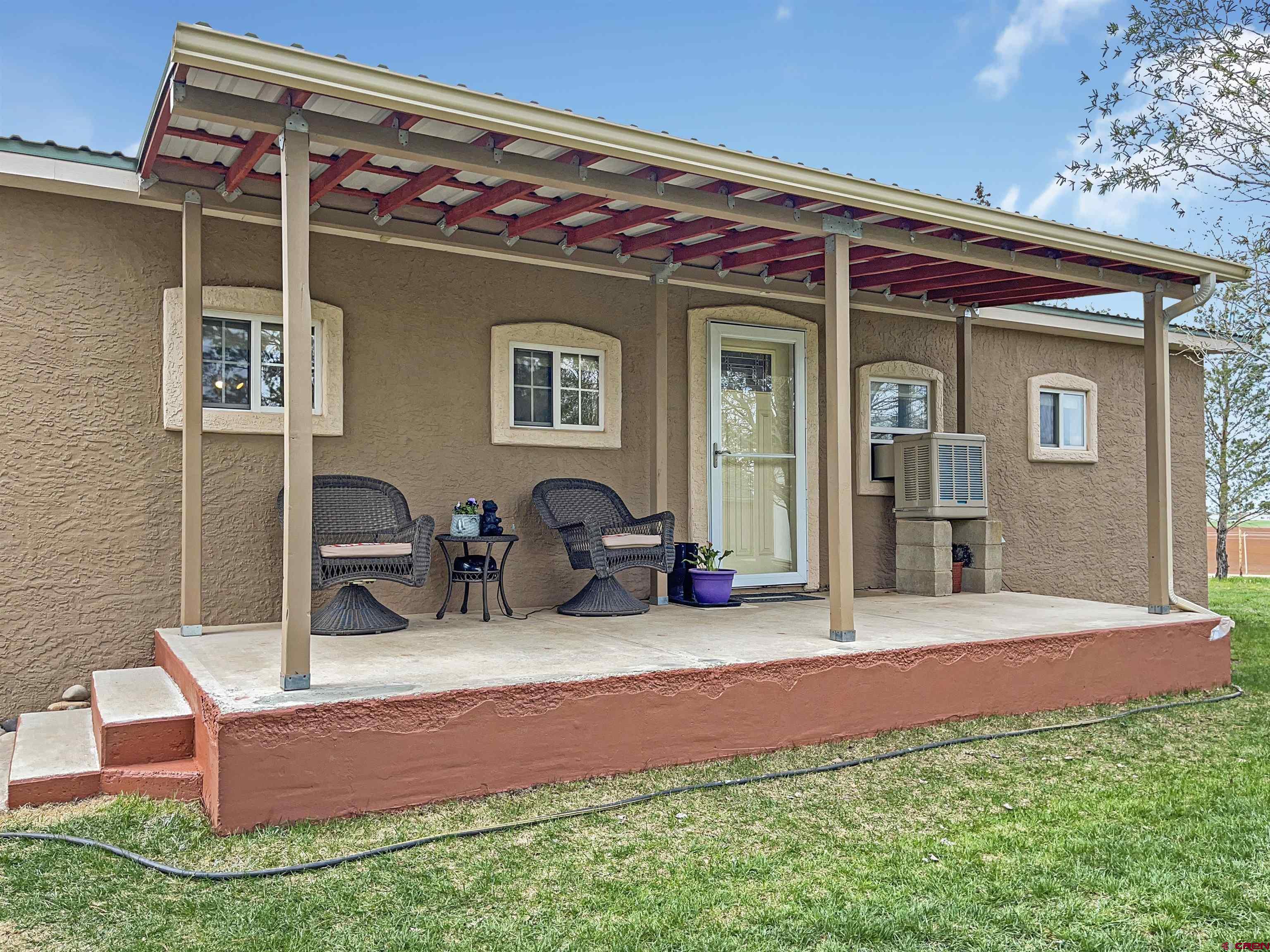 15200 Rd CC Pleasant View, CO 81331 - Photo 8 of 35 a front view of a house with patio