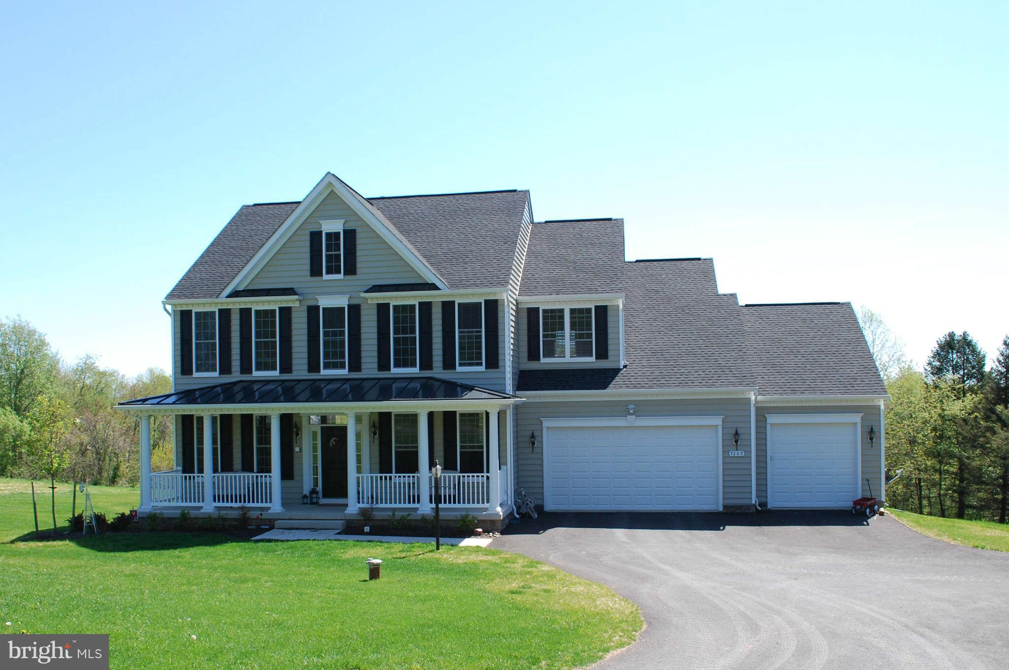 7209 Talbot Run Road Mount Airy, MD 21771 - Photo 1 of 25 a front view of a house with a yard table and chairs