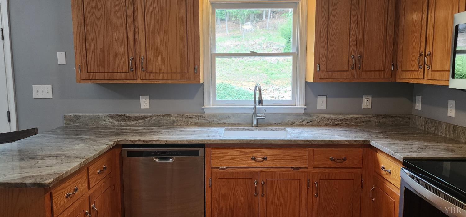297 Poor House Farm Road Amherst, VA 24521 - Photo 13 of 52 a kitchen with granite countertop cabinets sink and window