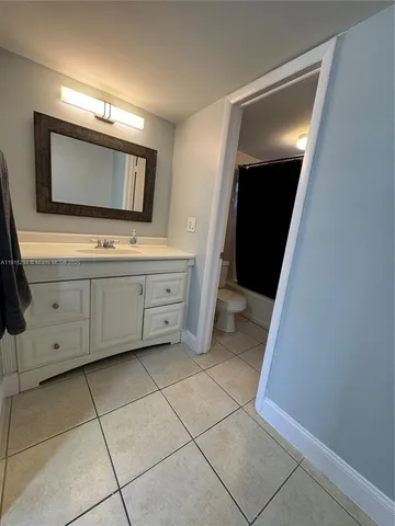 a bathroom with a toilet and a bath tub
