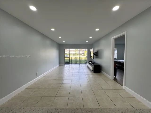 a spacious bedroom with a bed and a window