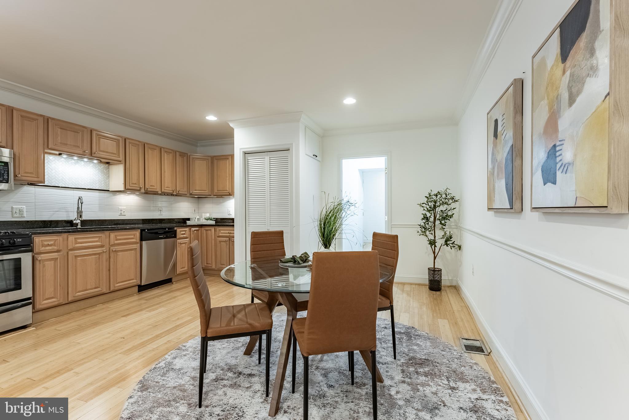 1840 D Street Northeast, Unit 1 Washington, DC 20002 - Photo 14 of 40 a kitchen with granite countertop white cabinets and stainless steel appliances