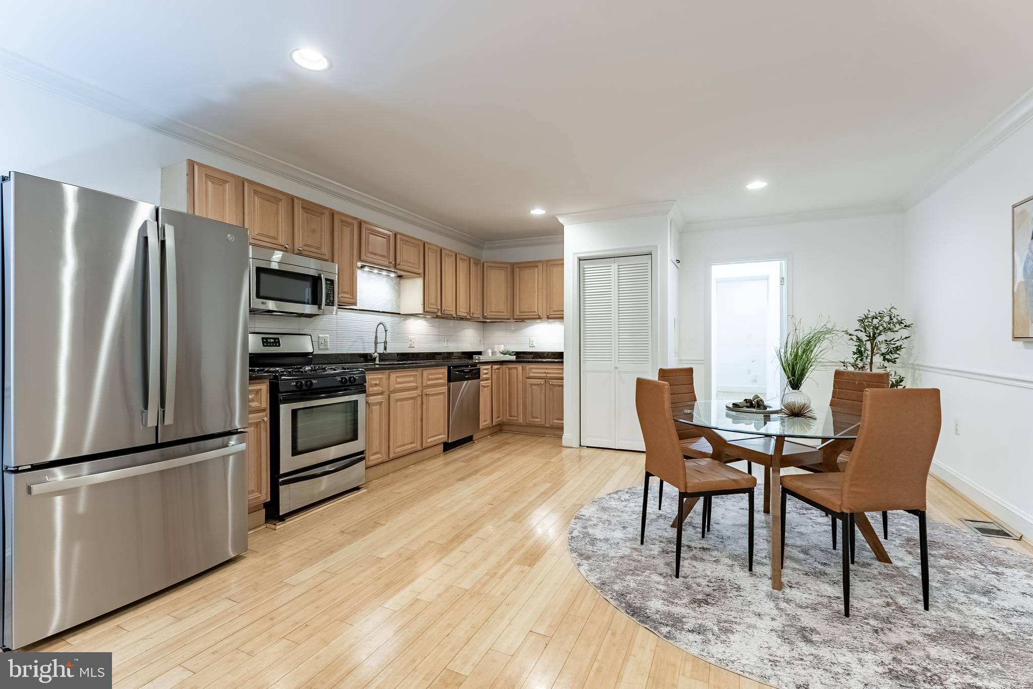 1840 D Street Northeast, Unit 1 Washington, DC 20002 - Photo 15 of 40 a kitchen with stainless steel appliances kitchen island granite countertop a refrigerator and a stove top oven