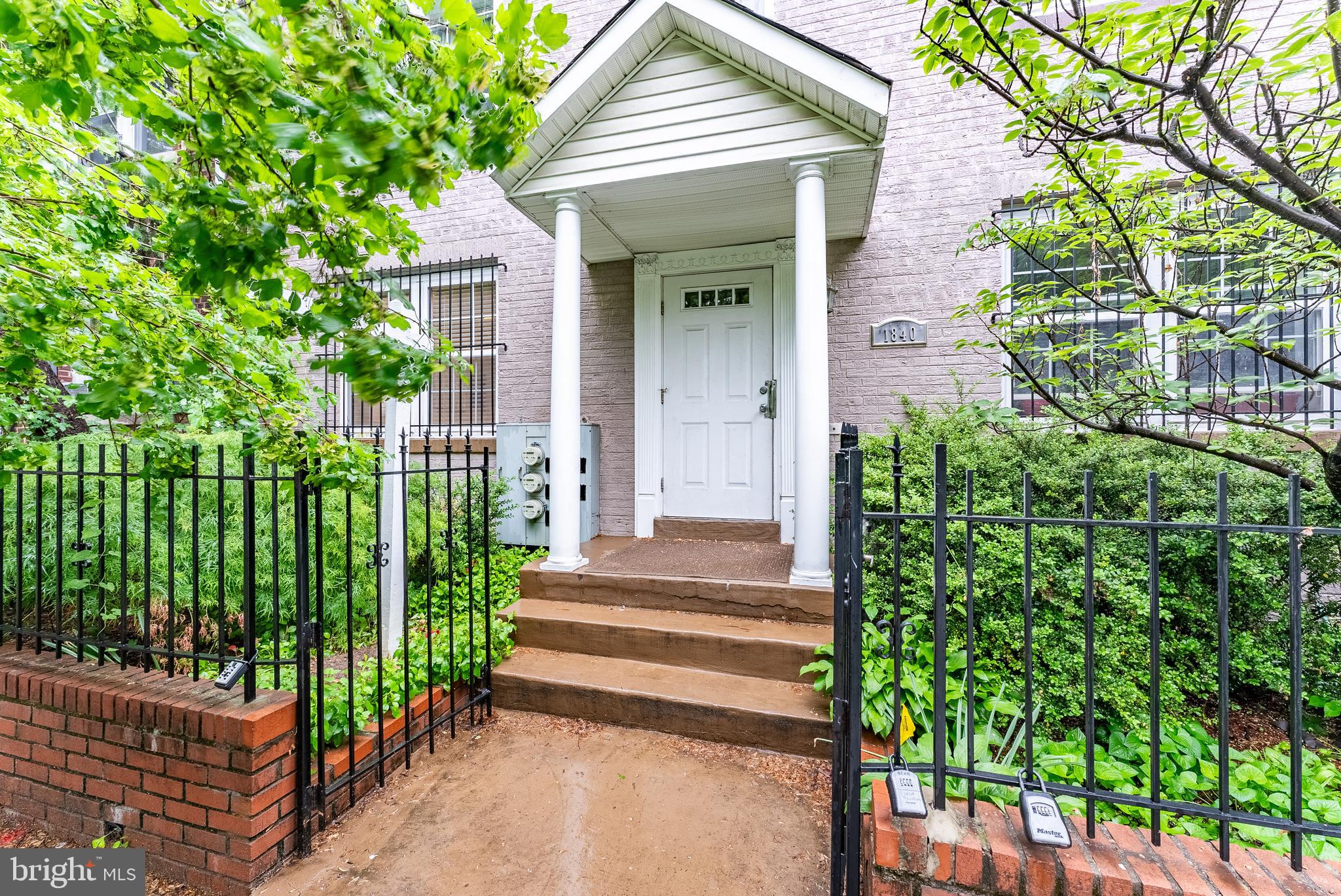1840 D Street Northeast, Unit 1 Washington, DC 20002 - Photo 2 of 40 a front view of a house with a garden