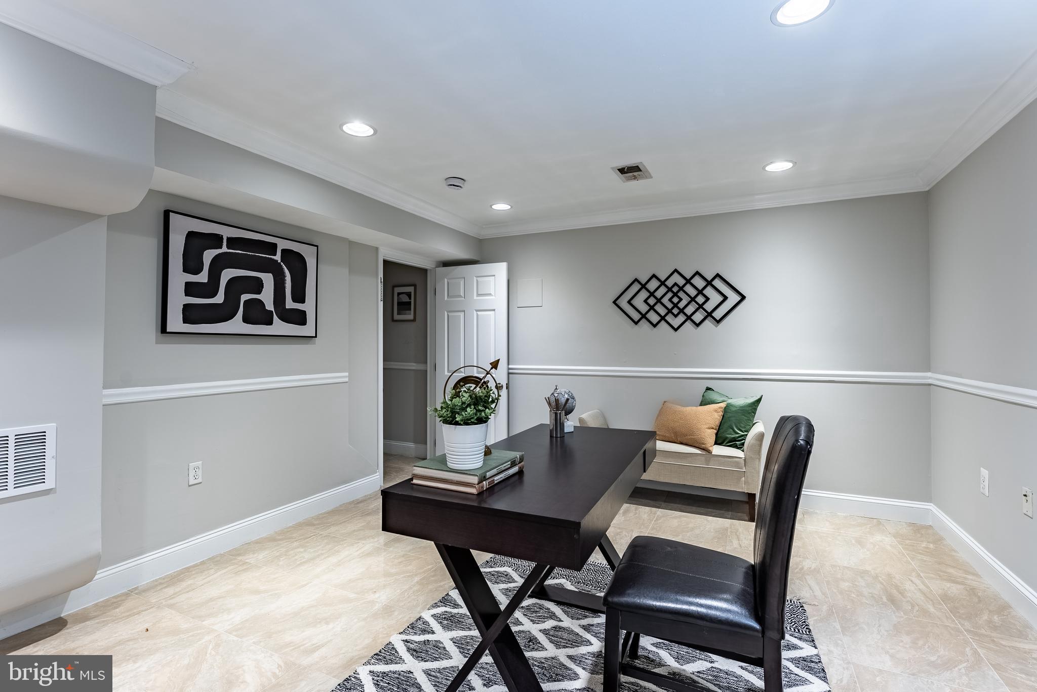 1840 D Street Northeast, Unit 1 Washington, DC 20002 - Photo 25 of 40 a work room with furniture and paintings on the wall