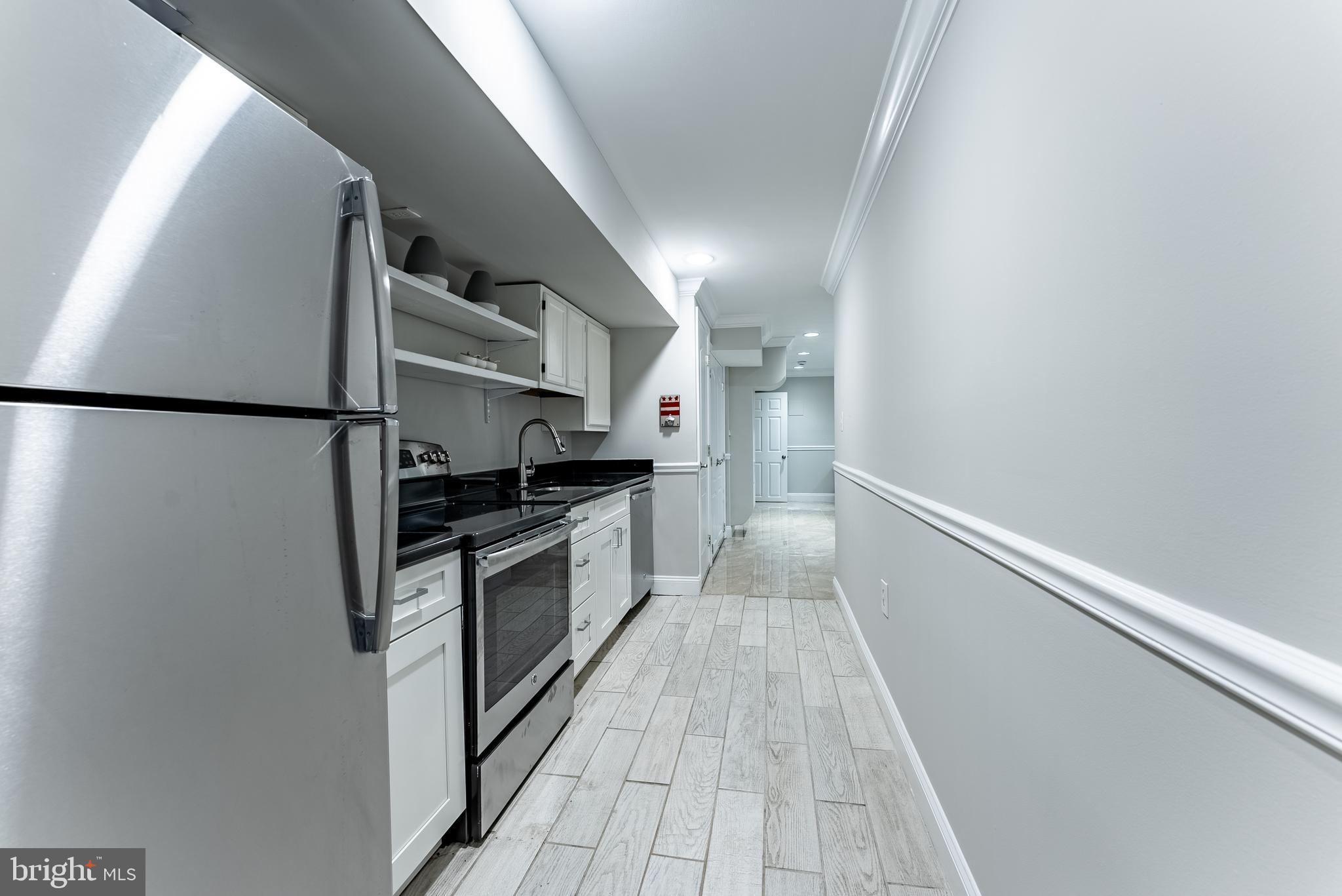 1840 D Street Northeast, Unit 1 Washington, DC 20002 - Photo 29 of 40 a kitchen with stainless steel appliances a refrigerator and a stove