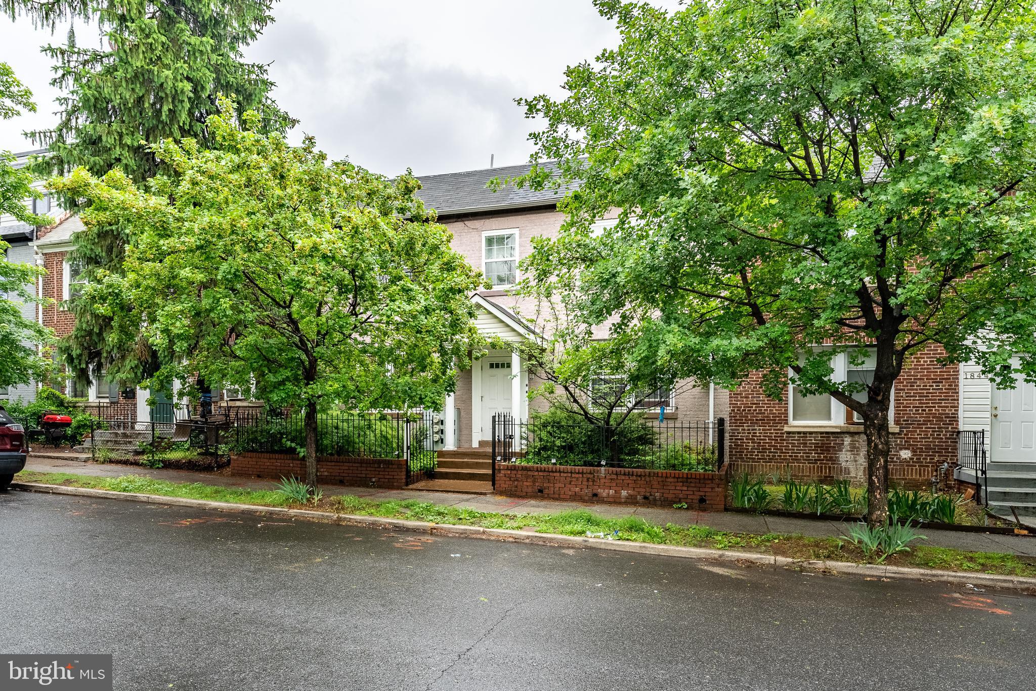 1840 D Street Northeast, Unit 1 Washington, DC 20002 - Photo 37 of 40 a view of a house with a large tree and plants