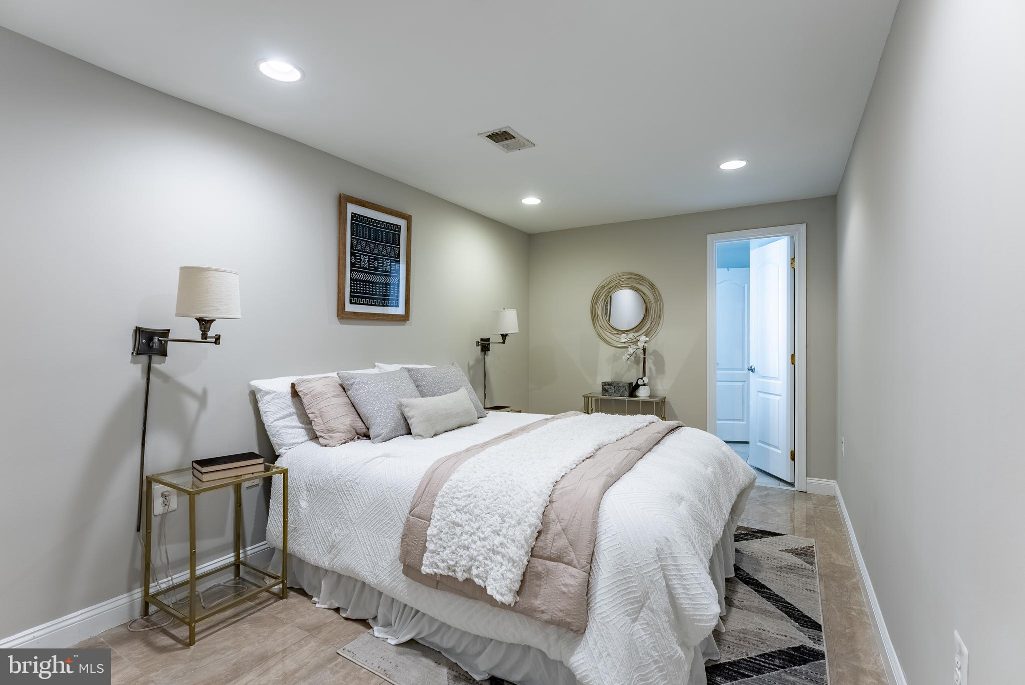 1840 D Street Northeast, Unit 1 Washington, DC 20002 - Photo 4 of 40 a bedroom with a bed and a chandelier