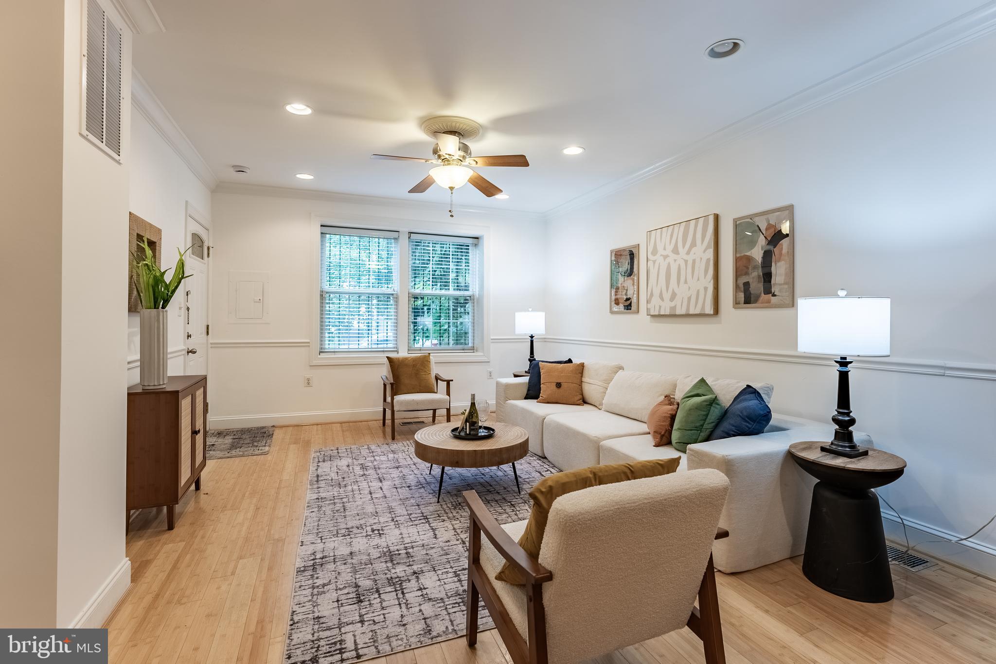 1840 D Street Northeast, Unit 1 Washington, DC 20002 - Photo 8 of 40 a living room with furniture a window and a chandelier