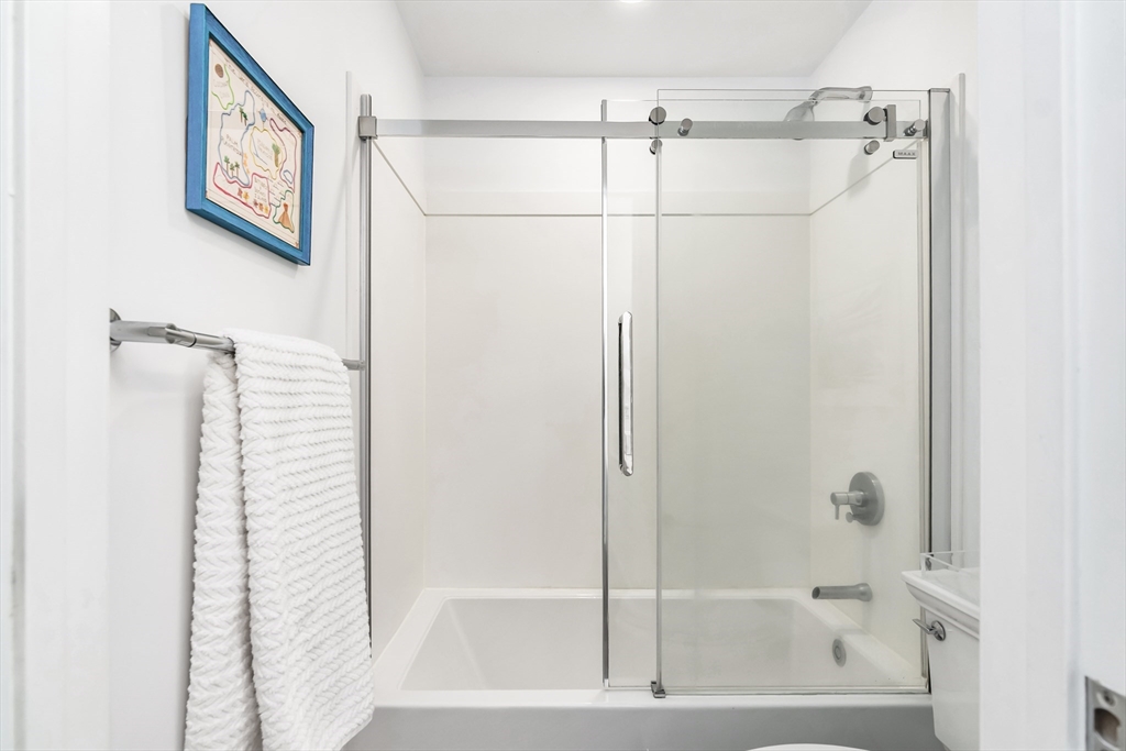 6 Summer Street, Unit D Manchester, MA 01944 - Photo 25 of 31 a bathroom with a shower and a bathtub