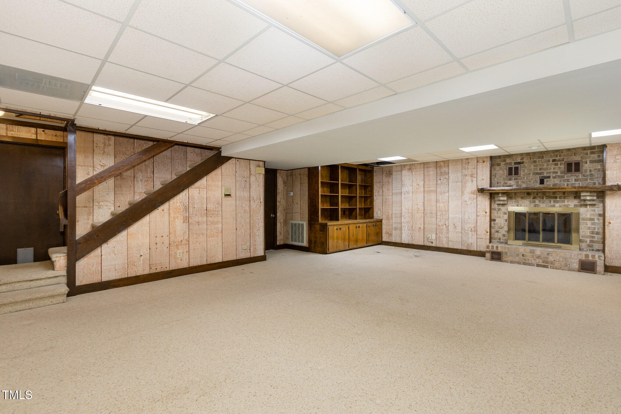 3514 Ridge Road Durham, NC 27705 - Photo 30 of 38 a view of an empty room with a fireplace and cabinet