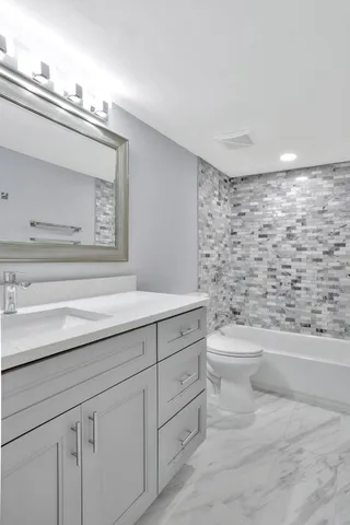 a bathroom with a toilet a sink and bathtub