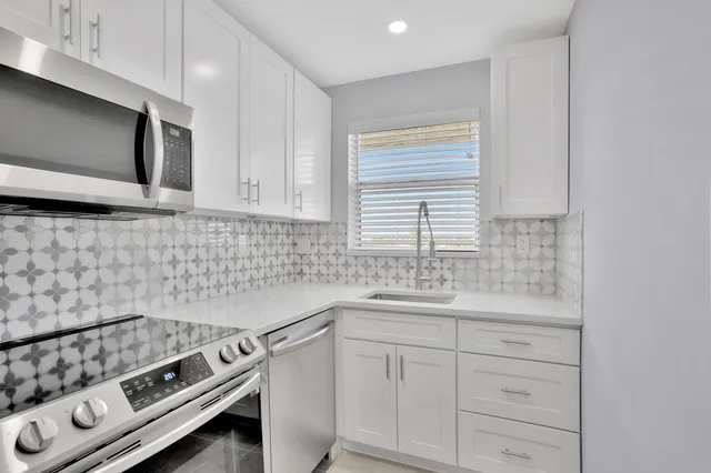 a kitchen with a sink stove and microwave