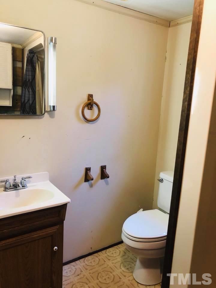 440 Ole Cabin Road Roxboro, NC 27574 - Photo 13 of 23 a bathroom with a sink and a mirror