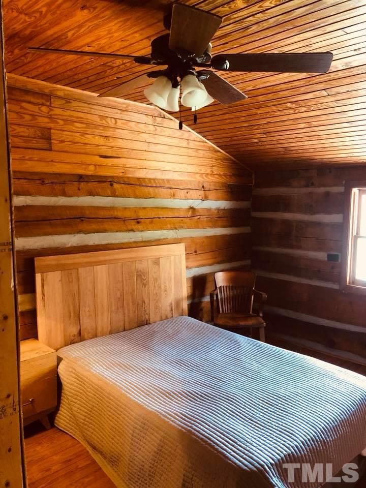 440 Ole Cabin Road Roxboro, NC 27574 - Photo 15 of 23 a bedroom with a bed and a ceiling fan