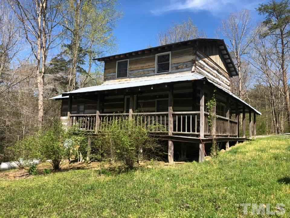 440 Ole Cabin Road Roxboro, NC 27574 - Photo 3 of 23 a house with trees in the background