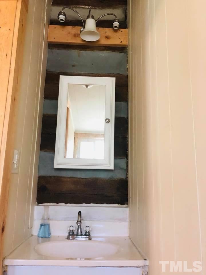 440 Ole Cabin Road Roxboro, NC 27574 - Photo 21 of 23 a bathroom with a sink and a mirror