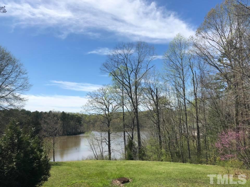 440 Ole Cabin Road Roxboro, NC 27574 - Photo 4 of 23 a view of a lake with a yard
