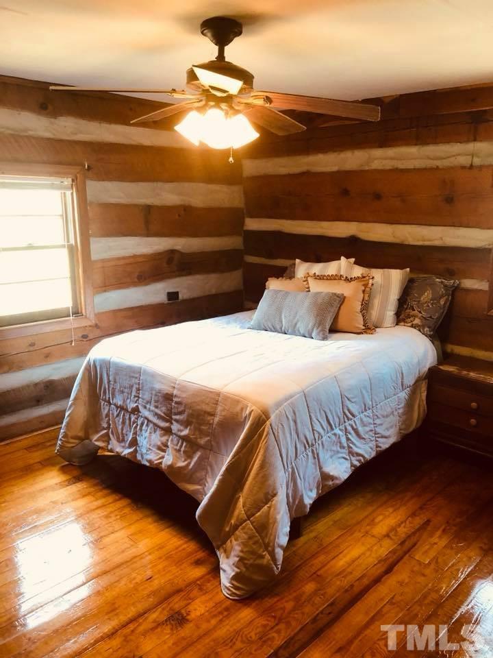 440 Ole Cabin Road Roxboro, NC 27574 - Photo 10 of 23 a bedroom with a bed and a night stand