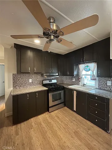 a bathroom with a granite countertop sink toilet and mirror